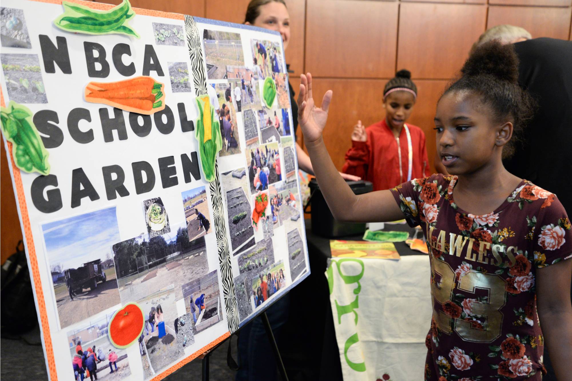 Student standing next to poster at Showcase